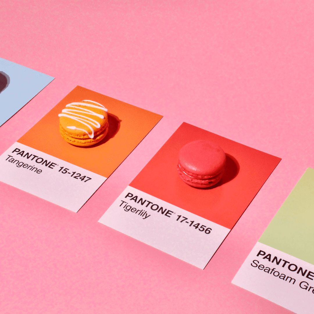 A range of Pantone's 2026 colours with orange and red on display