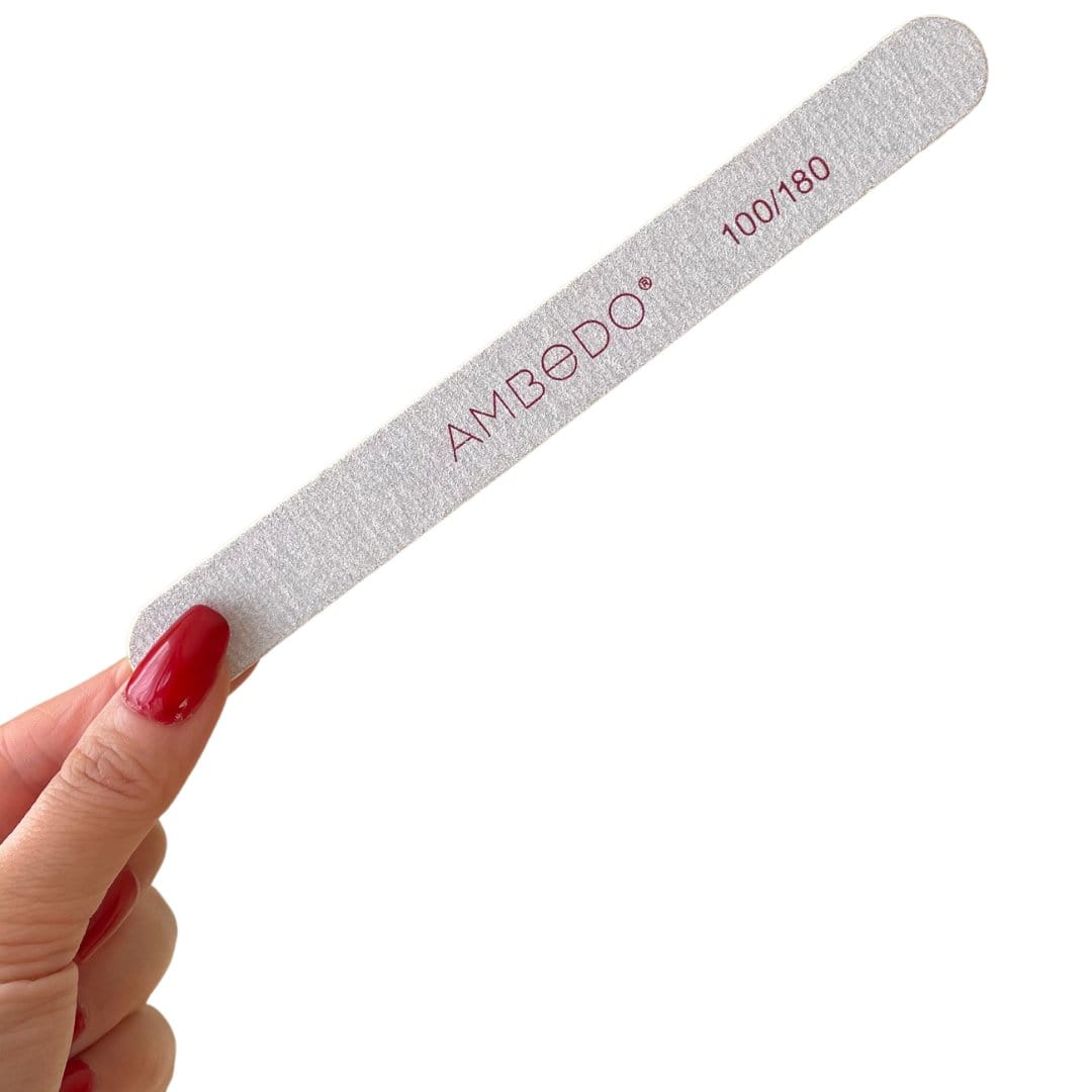 A white Ambedo nail file with a fine-grit surface for shaping and smoothing nails.